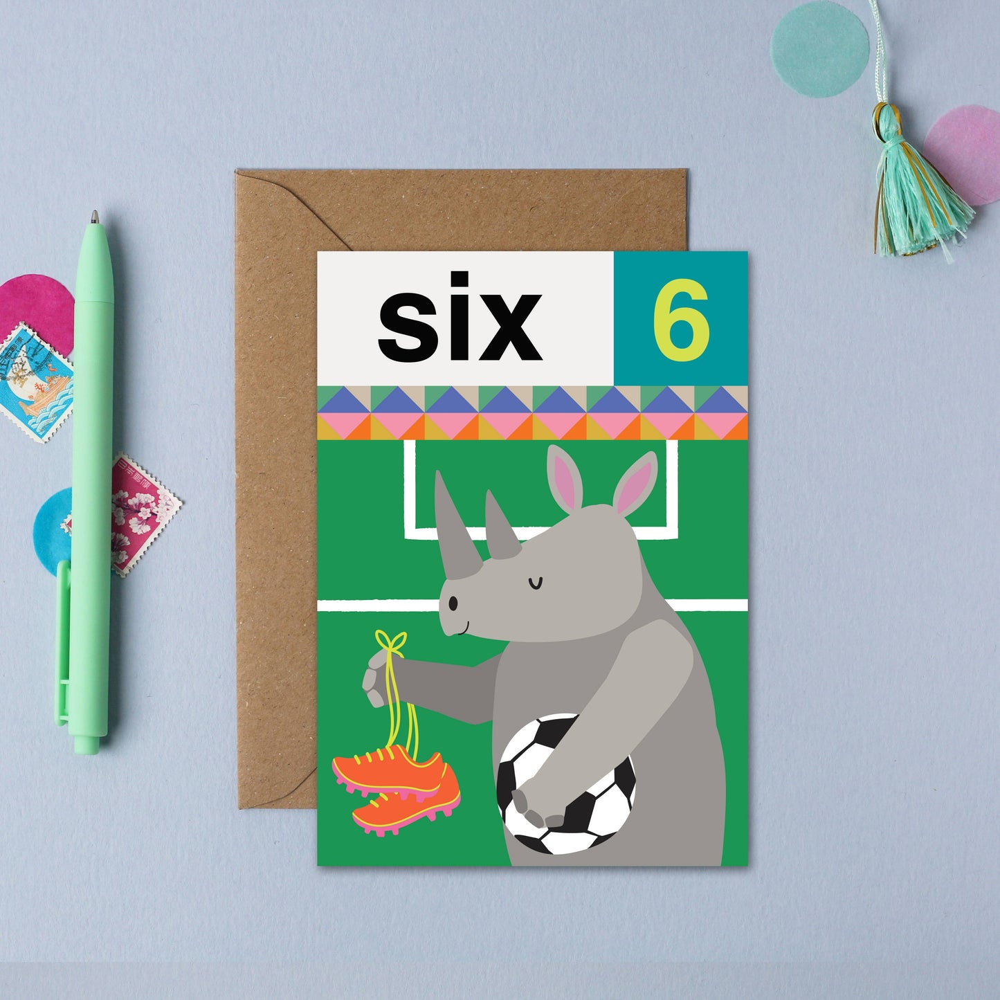 Eco-friendly Rhino 6th Birthday Card for football-loving children, showing a happy rhino with football boots and ball, made from sustainably sourced card with a recyclable envelope.