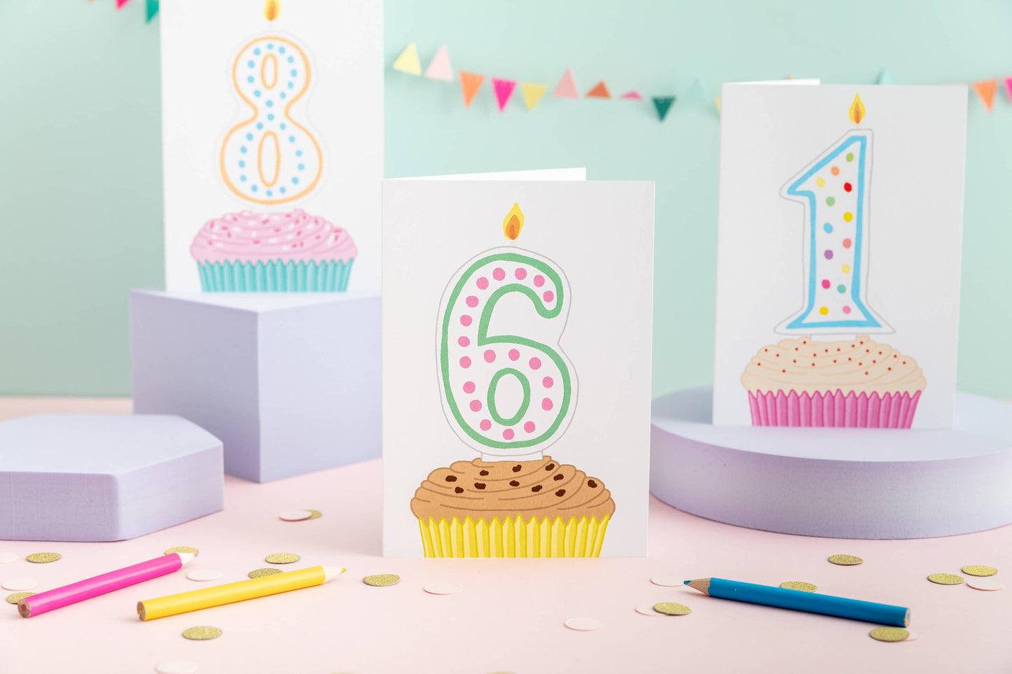 Brightly coloured 6th birthday greeting card featuring a cupcake with a number 6 candle on sustainably sourced white card, with a Kraft envelope.