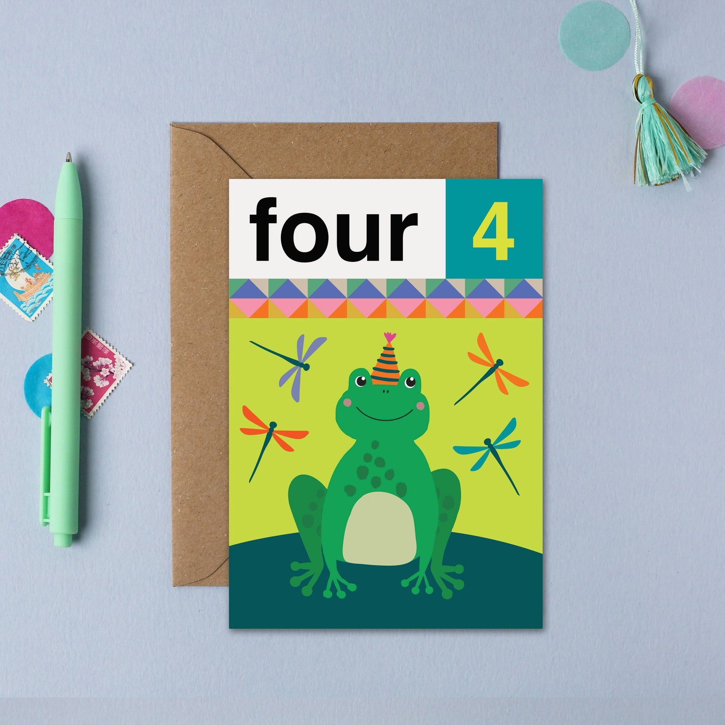 Playful frog 4th birthday card for children, featuring dragonflies and a large 'four 4' caption, printed on sustainably sourced card.