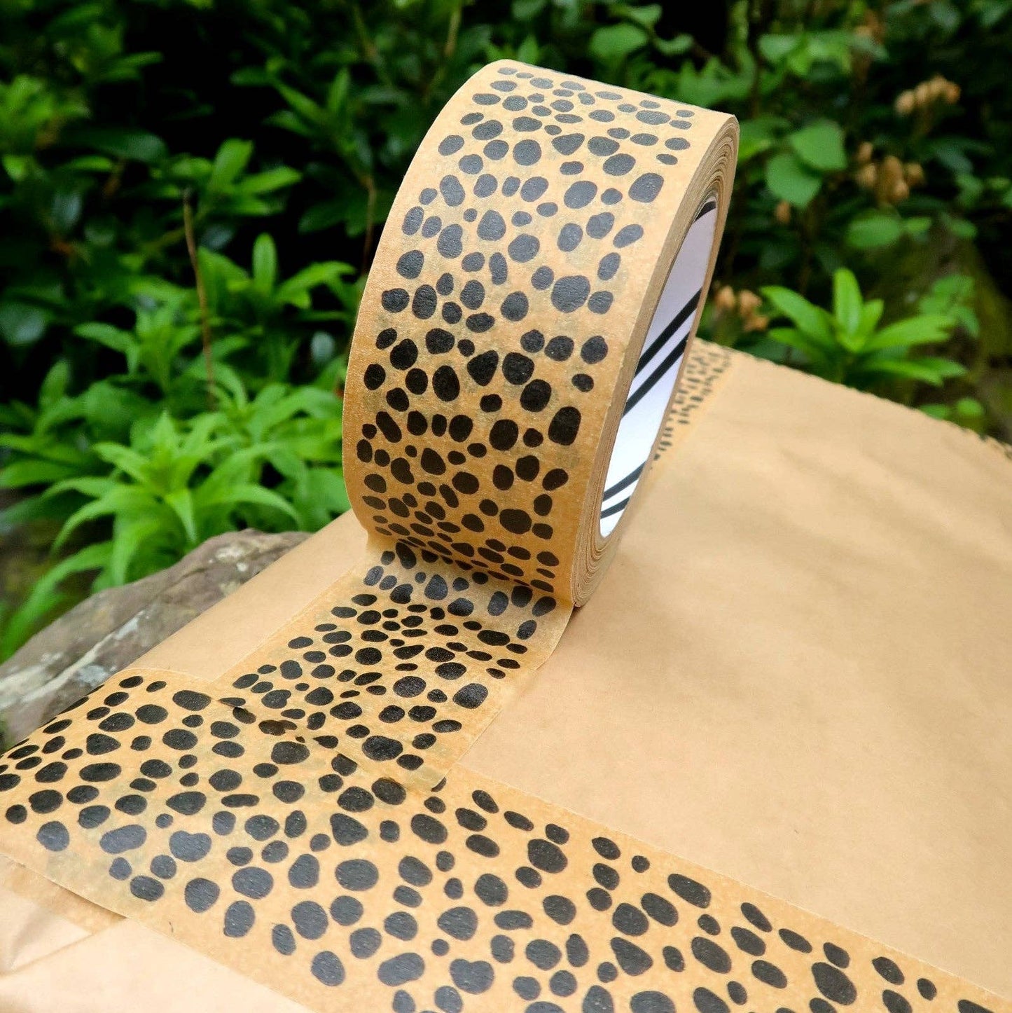 Roll of black and white eco animal print paper tape, 48mm wide, plastic-free for sustainable gift wrapping.