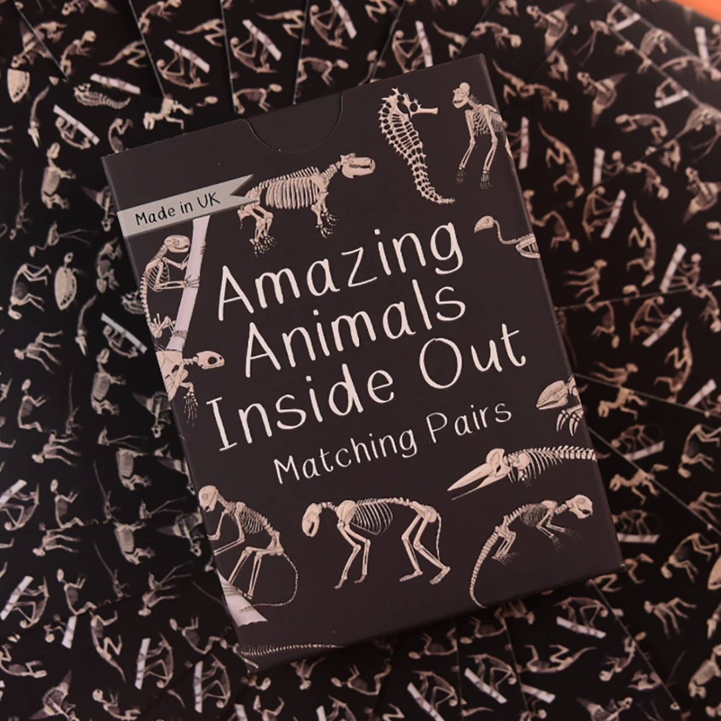 Amazing Animals Inside Out Matching Pairs educational game for children, showing animal illustrations and x-ray cards on a sustainable card deck
