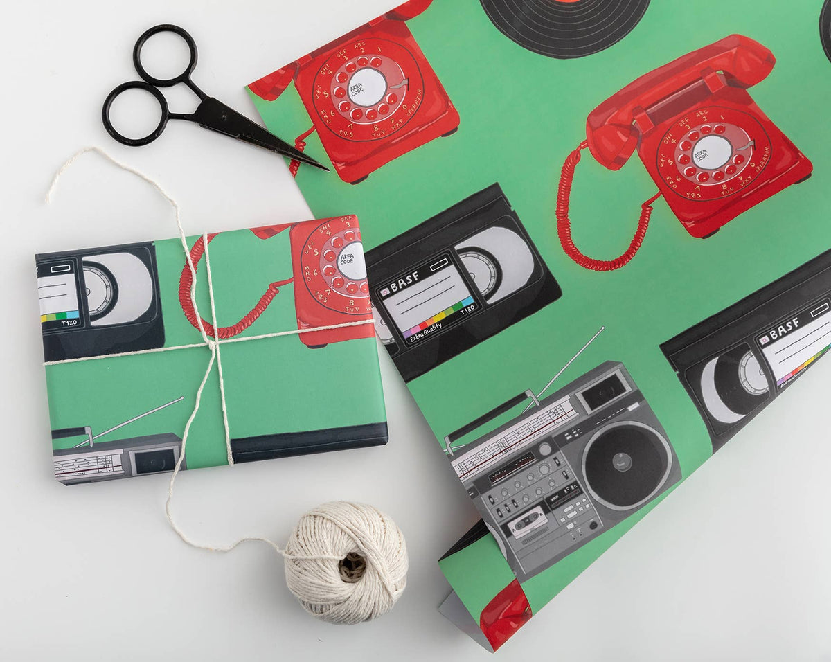 Retro boombox and VHS gift wrap on a bright green background, 100% recyclable and UK printed