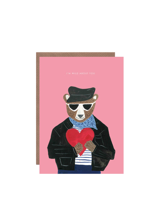Styled shot of 'Bear with Heart' greetings card, showing the front design and recycled kraft envelope.