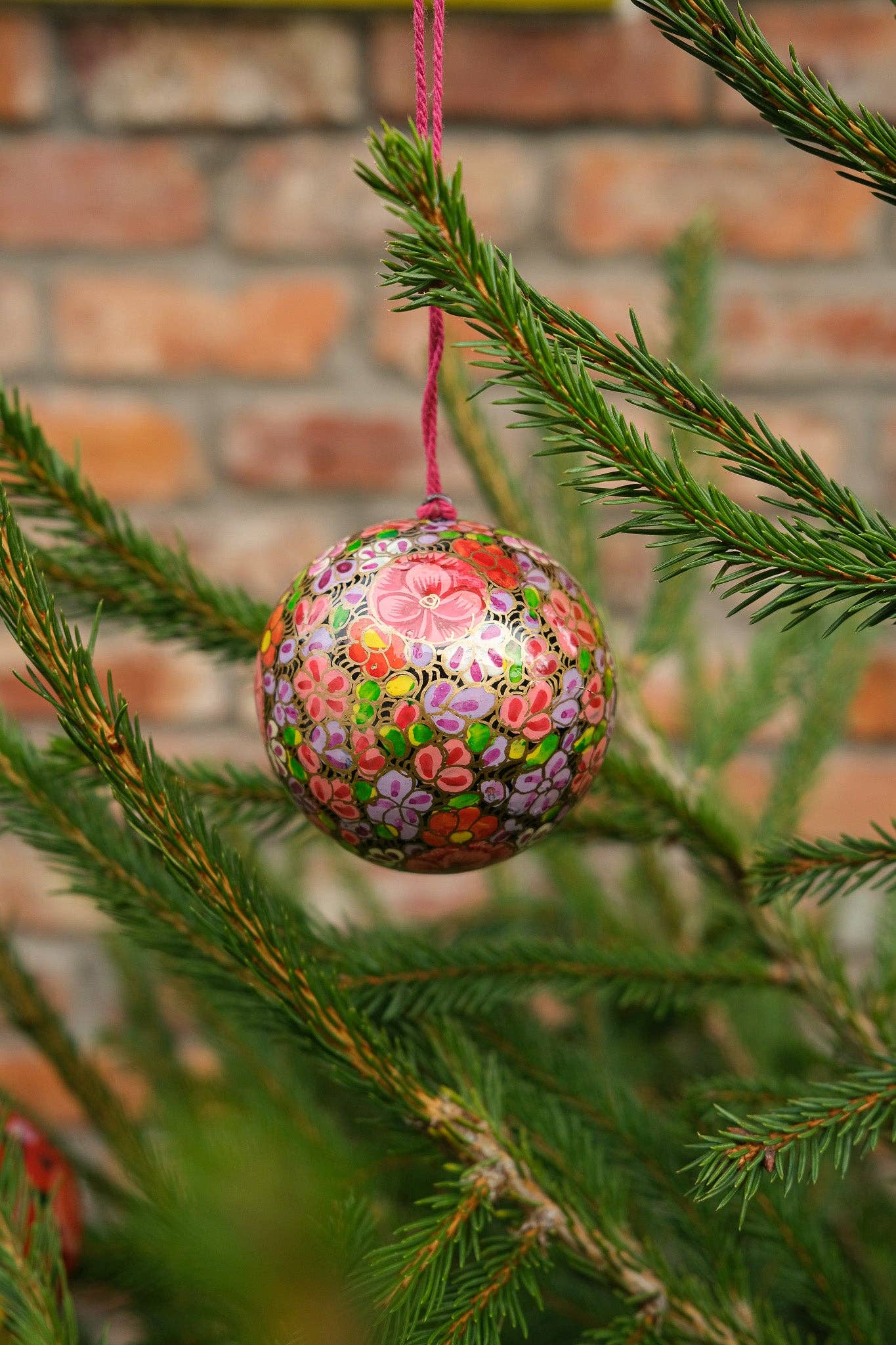 Several Gold Floret Papier Mâché Christmas Baubles displayed together, highlighting their unique handmade quality.