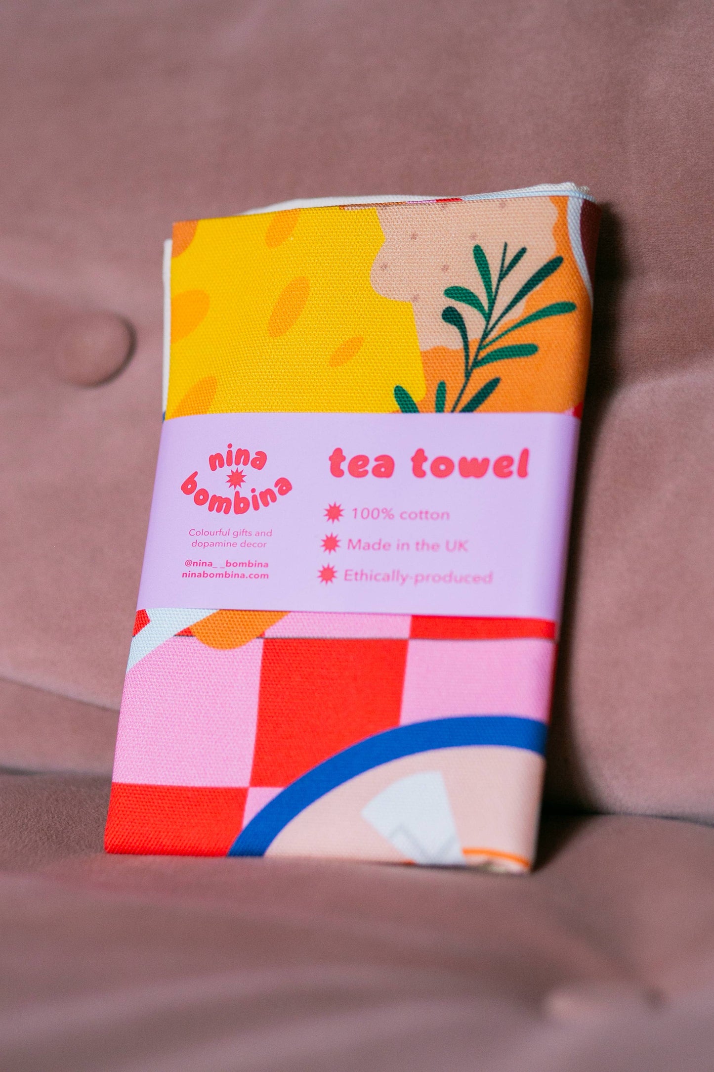 Checkered kitchen decor tea towel folded with paper belly band
