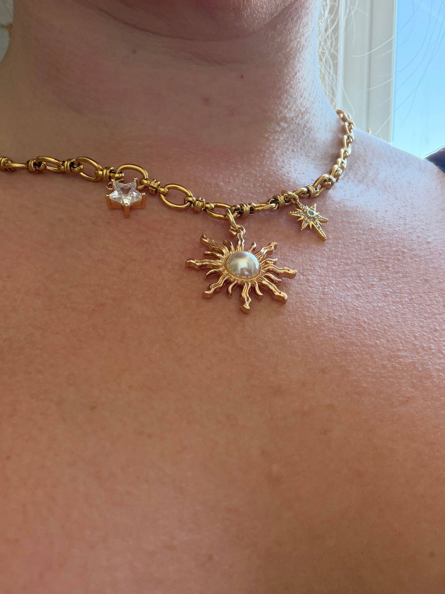 Close up of gold star charms on chunky chain