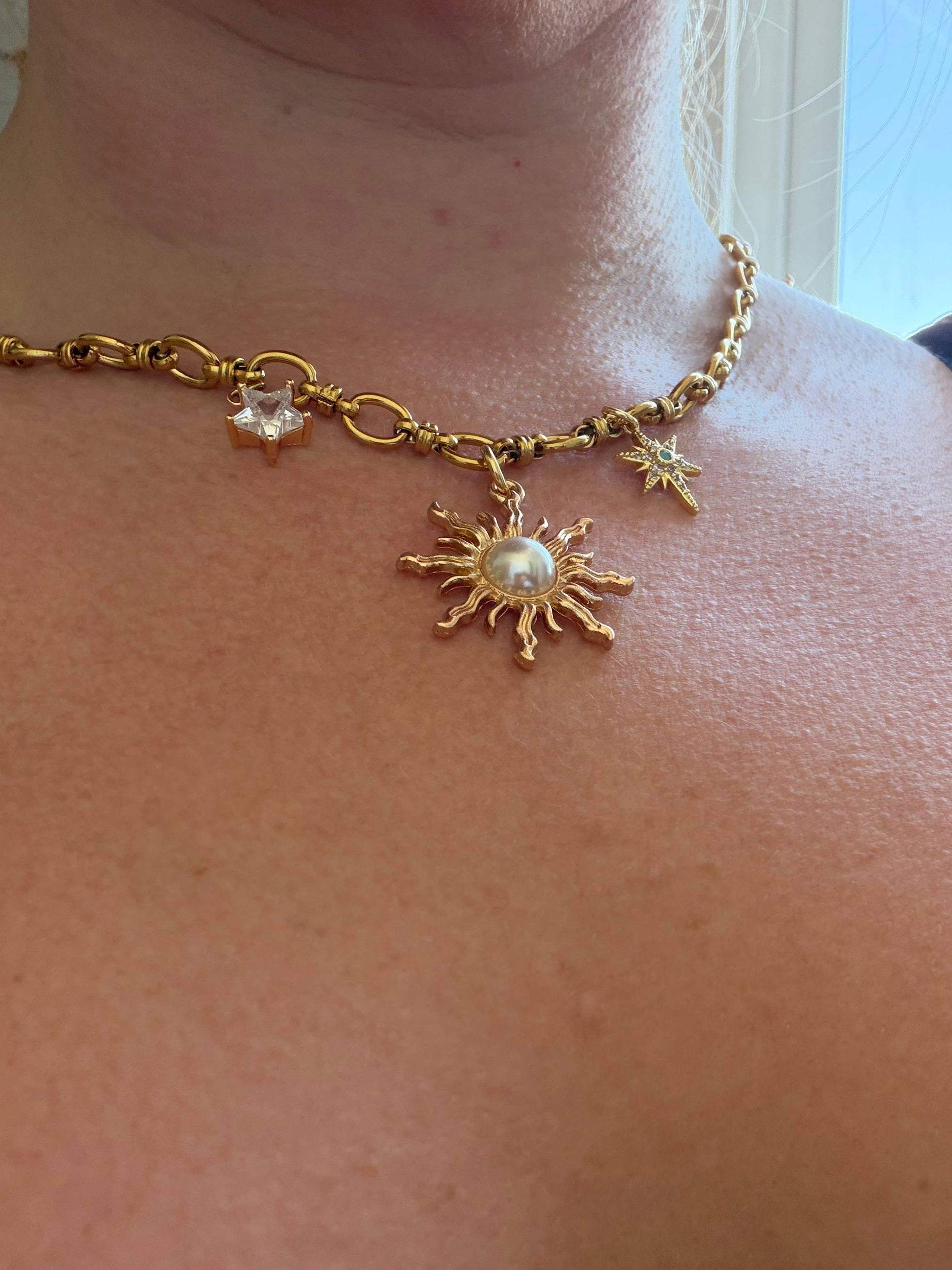 Close up of gold star charms on chunky chain