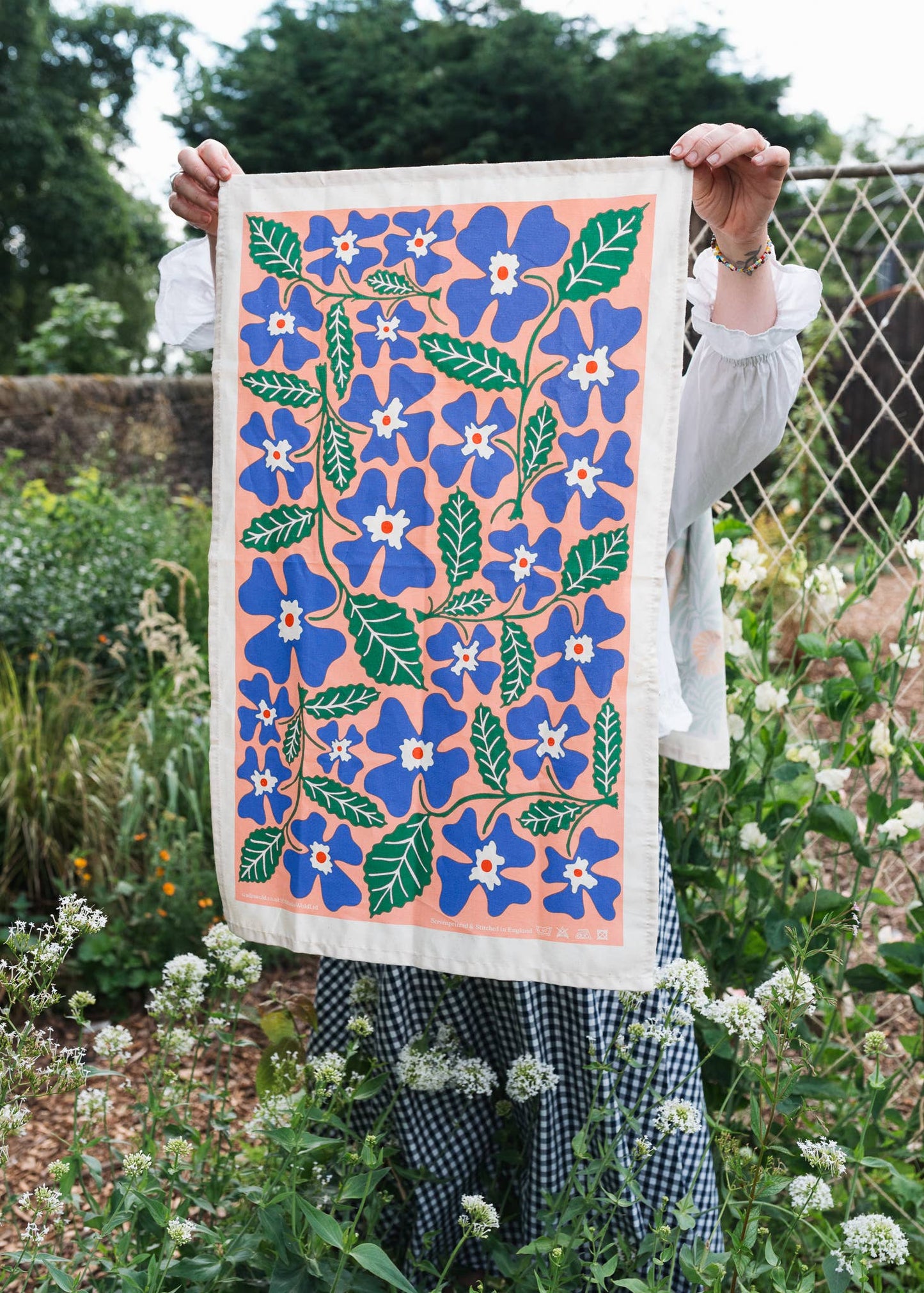 Primrose tea towel with floral screenprint on unbleached natural cotton by Studio Wald.
