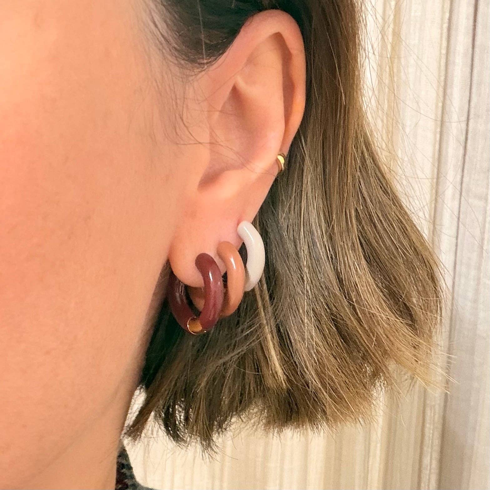 Model wearing Little Nell Gold Plated Enamel Hoops, showcasing size