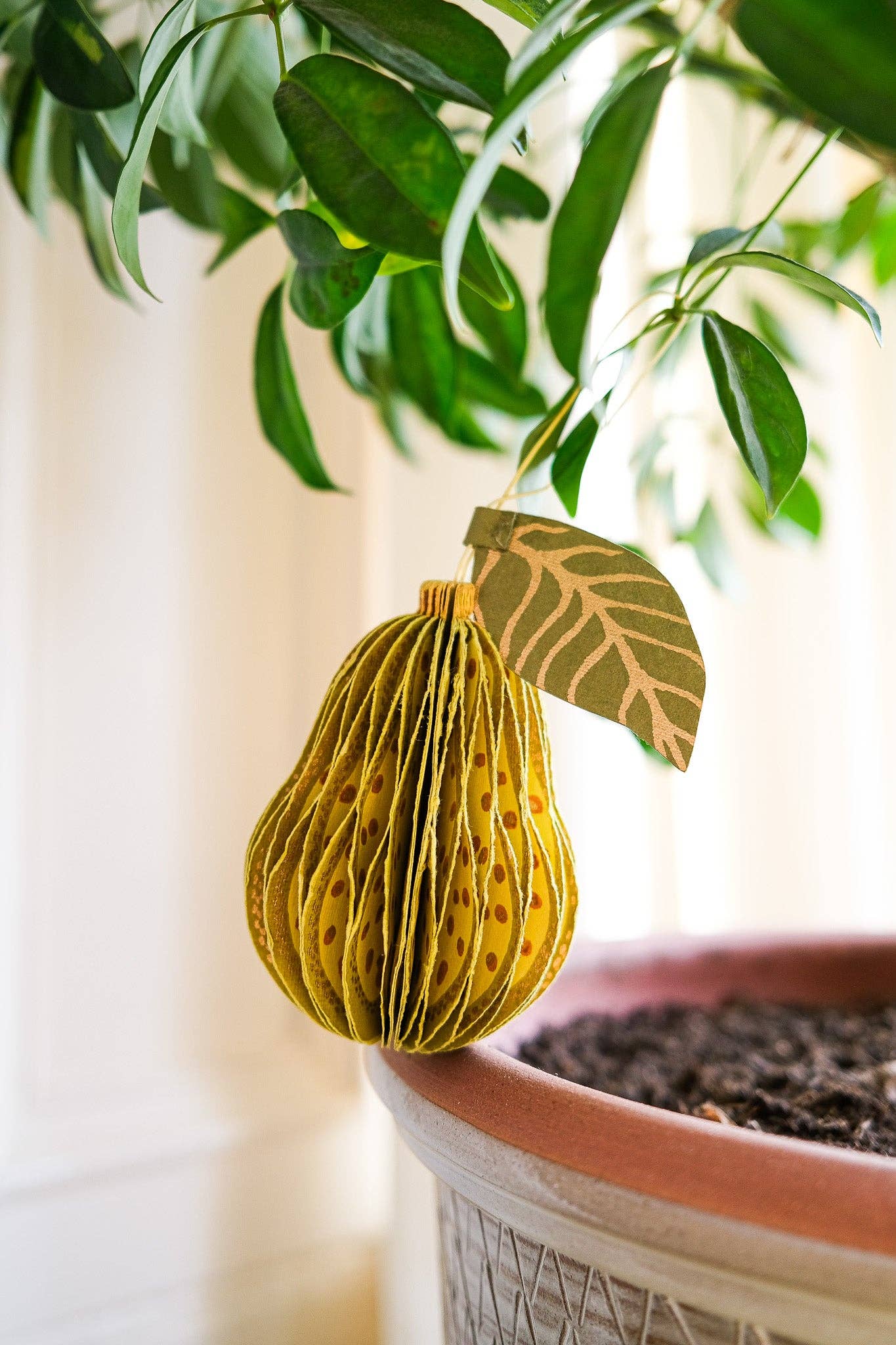 Recycled cotton paper pear honeycomb ornament, unfolded and hanging