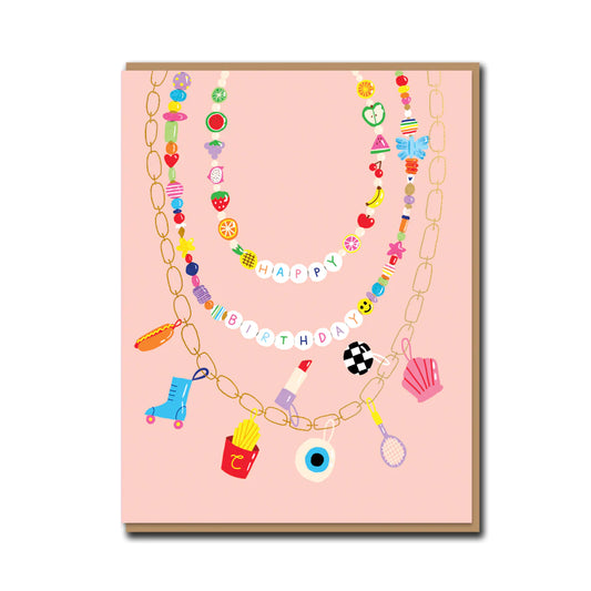 A colorful birthday card featuring a bead necklace design with various decorative items such as a shoe, apple, and pearl, on a pink background.