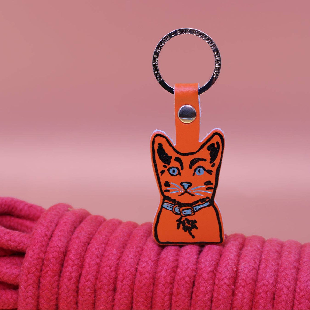 Tabby cat leather keyring held in hand showing scale