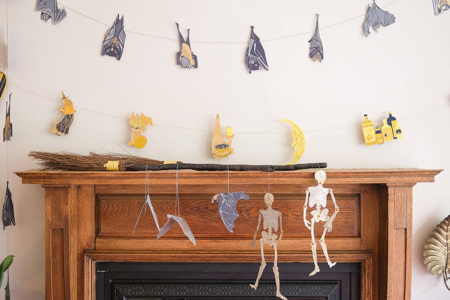 Dancing skeletons paper ornaments displayed in a home setting, adding a spooky yet charming touch.