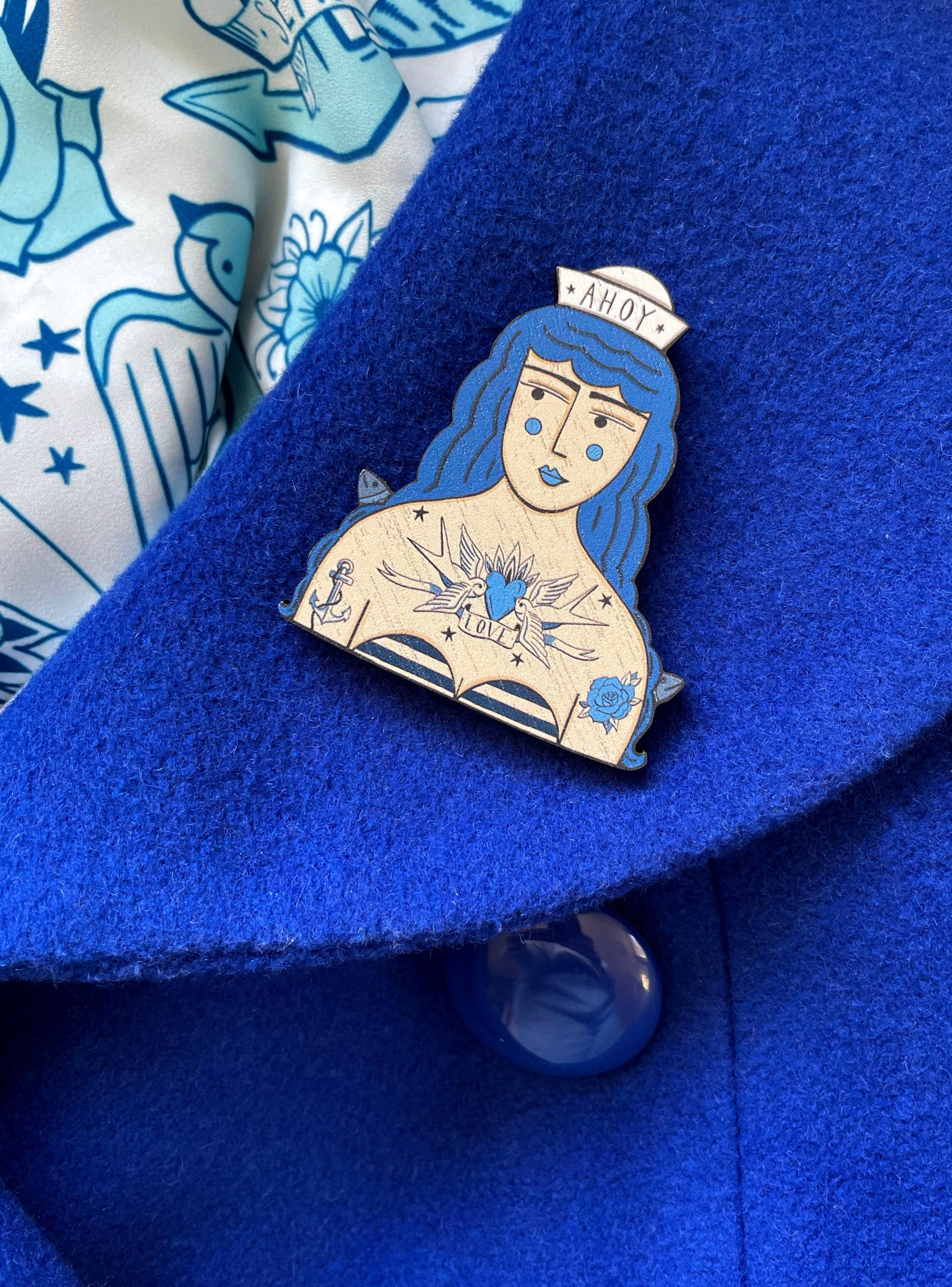 Tattooed Sailor Girl Brooch on its illustrated backing card