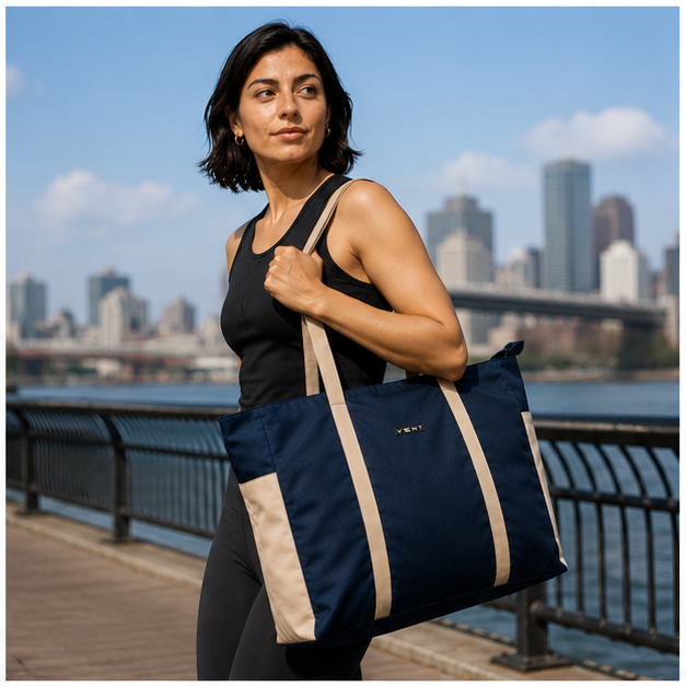 Interior of navy recycled shopper bag showing bottle pouch and pocket