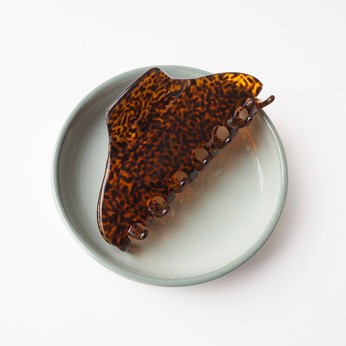 Marmite patterned medium hair claw on model