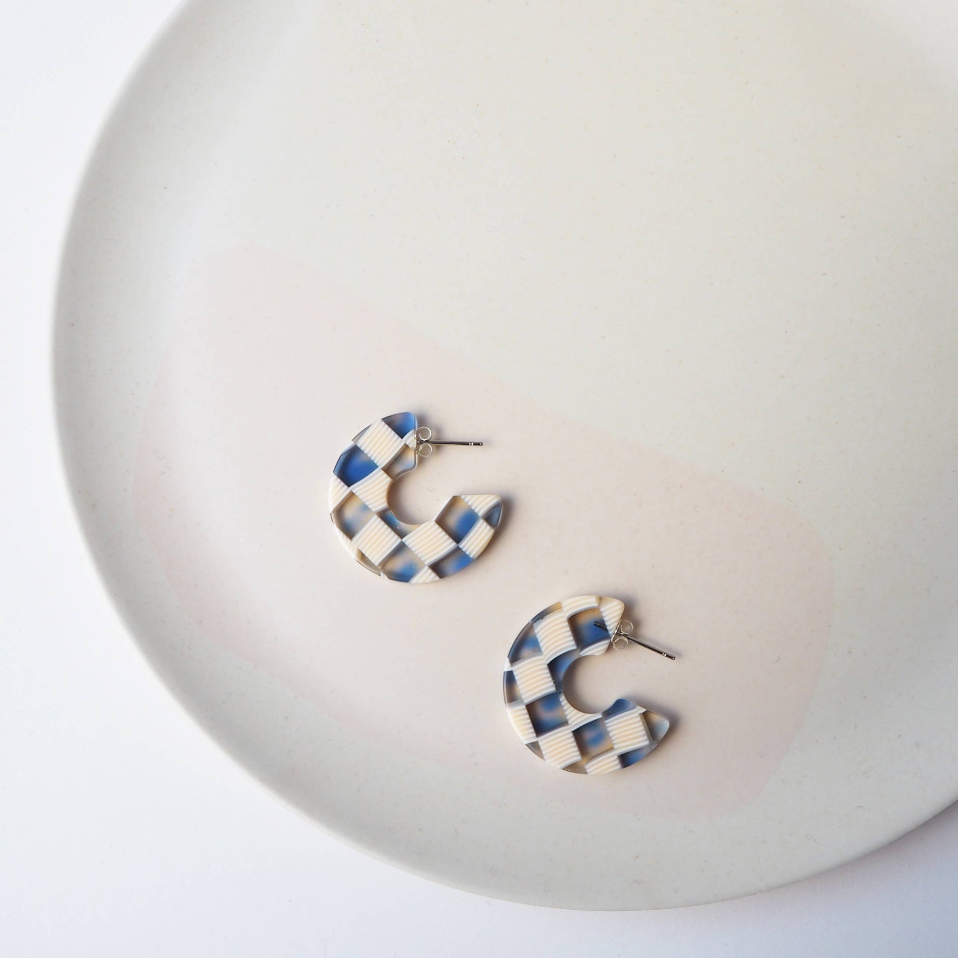 Detail of surgical steel posts on checkerboard earrings