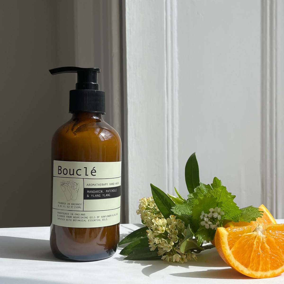 Mandarin, Patchouli and Ylang Ylang Essential Oil Hand Lotion in amber glass bottle