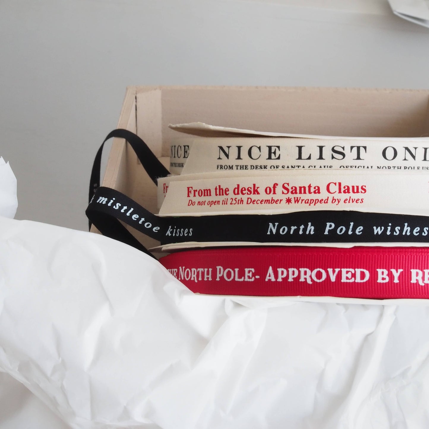 Box with festive ribbons and text on a white surface. Made in the UK by soch & co