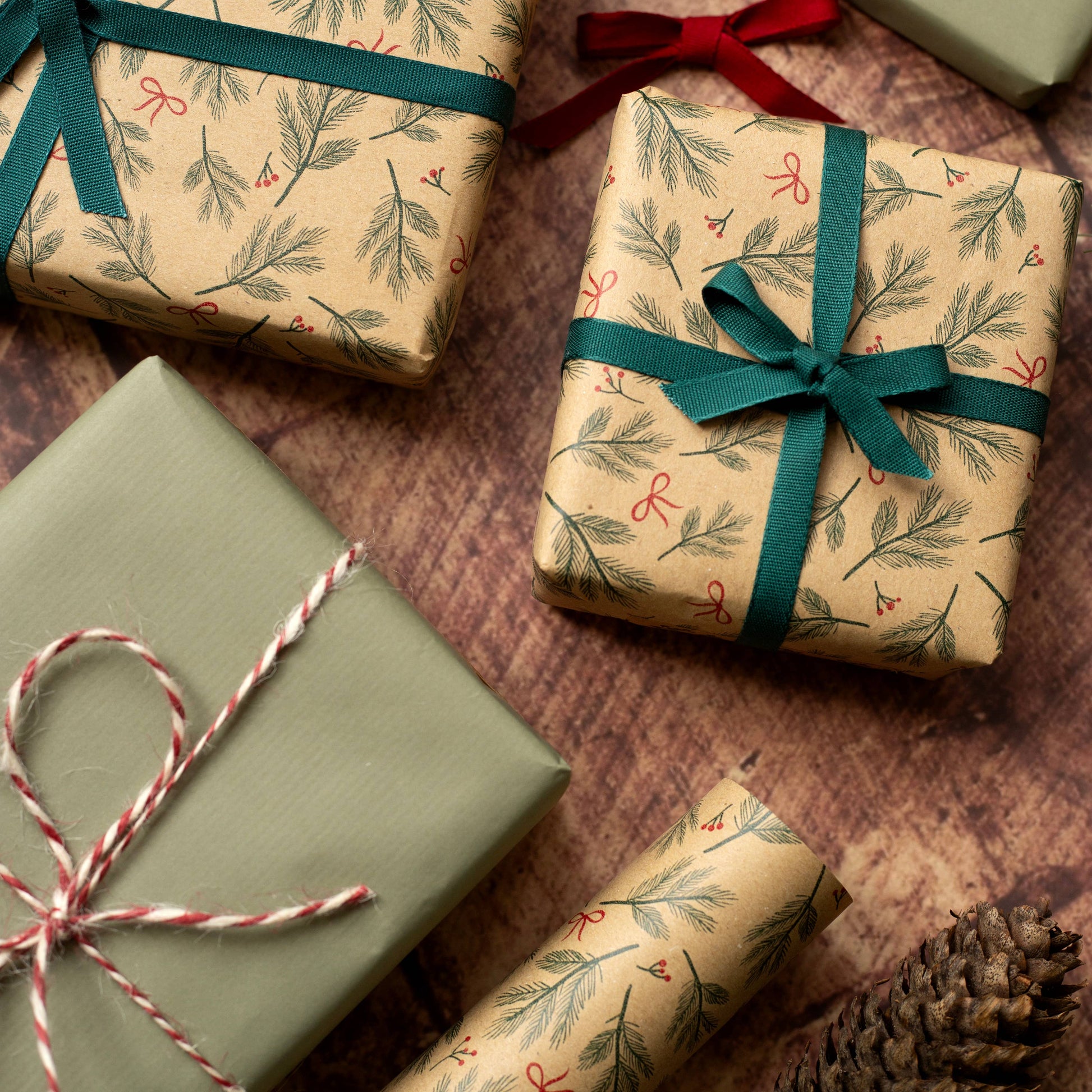 Festive Branches & Bows Christmas Gift Wrap, 5m roll, 500mm wide, 100% recycled brown kraft, eco-friendly sustainable wrapping paper.