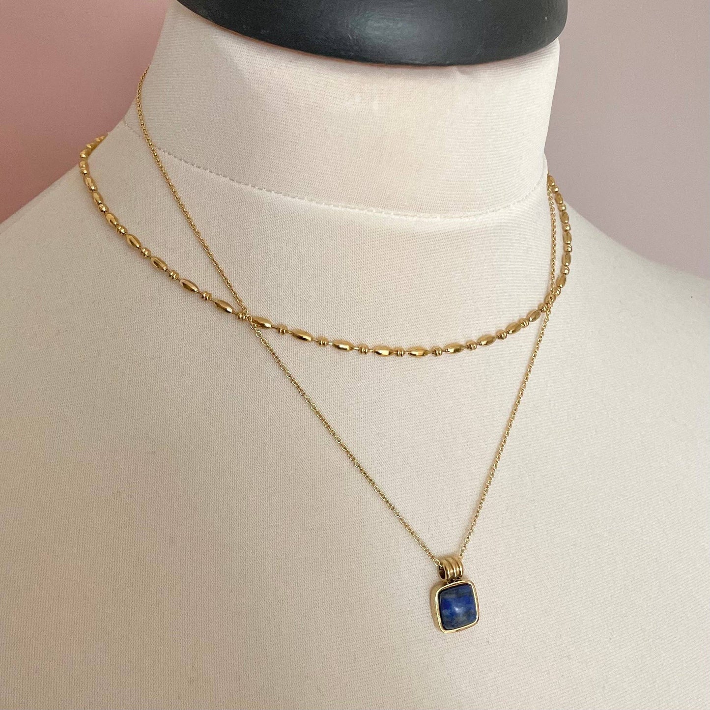 Close-up of Blue Lapis gemstone pendant and gold belcher chain
