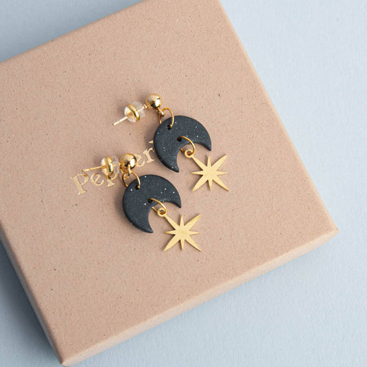 Close-up of Midnight Black Celestial Gold Star Drop Earrings, showing gold brass star and polymer clay texture.