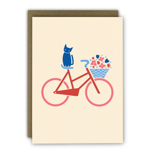Minimalist greeting card featuring a cat on a bicycle with flowers, printed on ivory card stock.