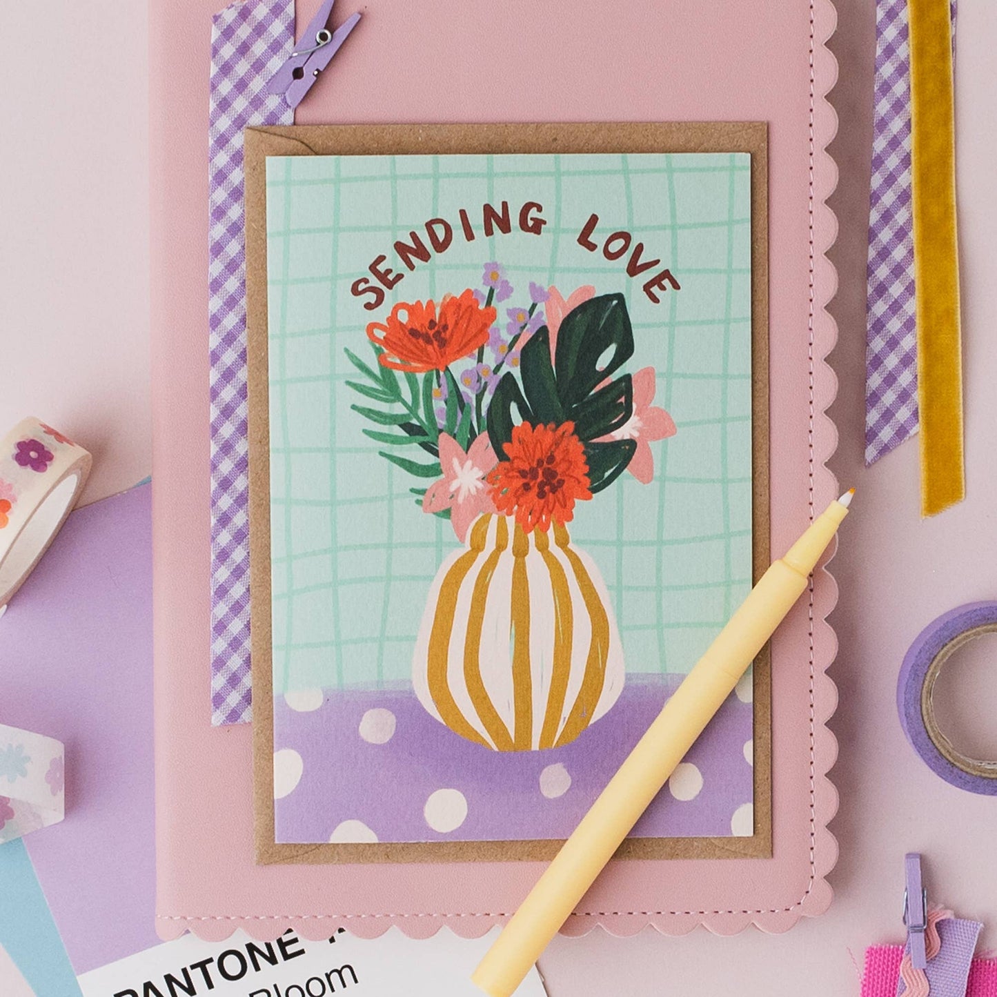 Hand drawn lettering reads 'Sending Love'. Illustrated greeting card with vase of flowers, printed onto premium textured card with a kraft envelope.