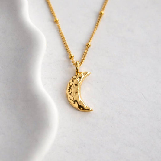 Gold Crescent Moon Necklace displayed on Augusta Jewellery branded card