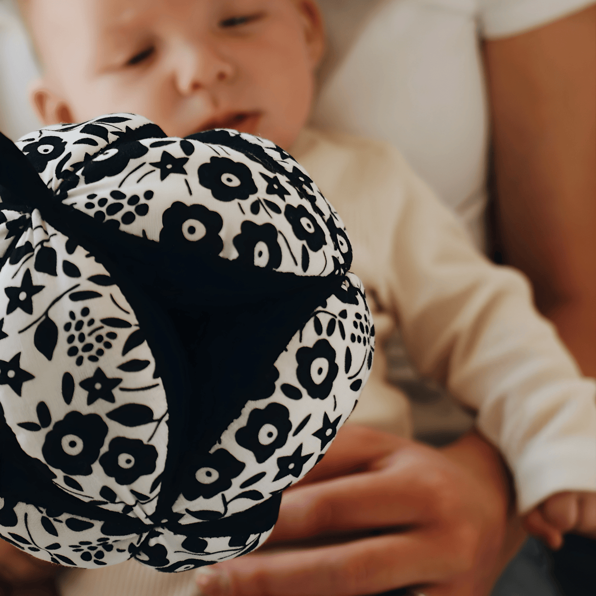 Baby interacting with the monochrome sensory grasp ball