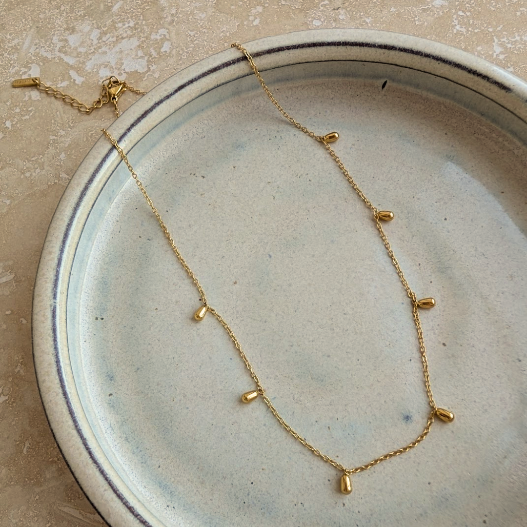 Close up of gold plated mini droplet pendants