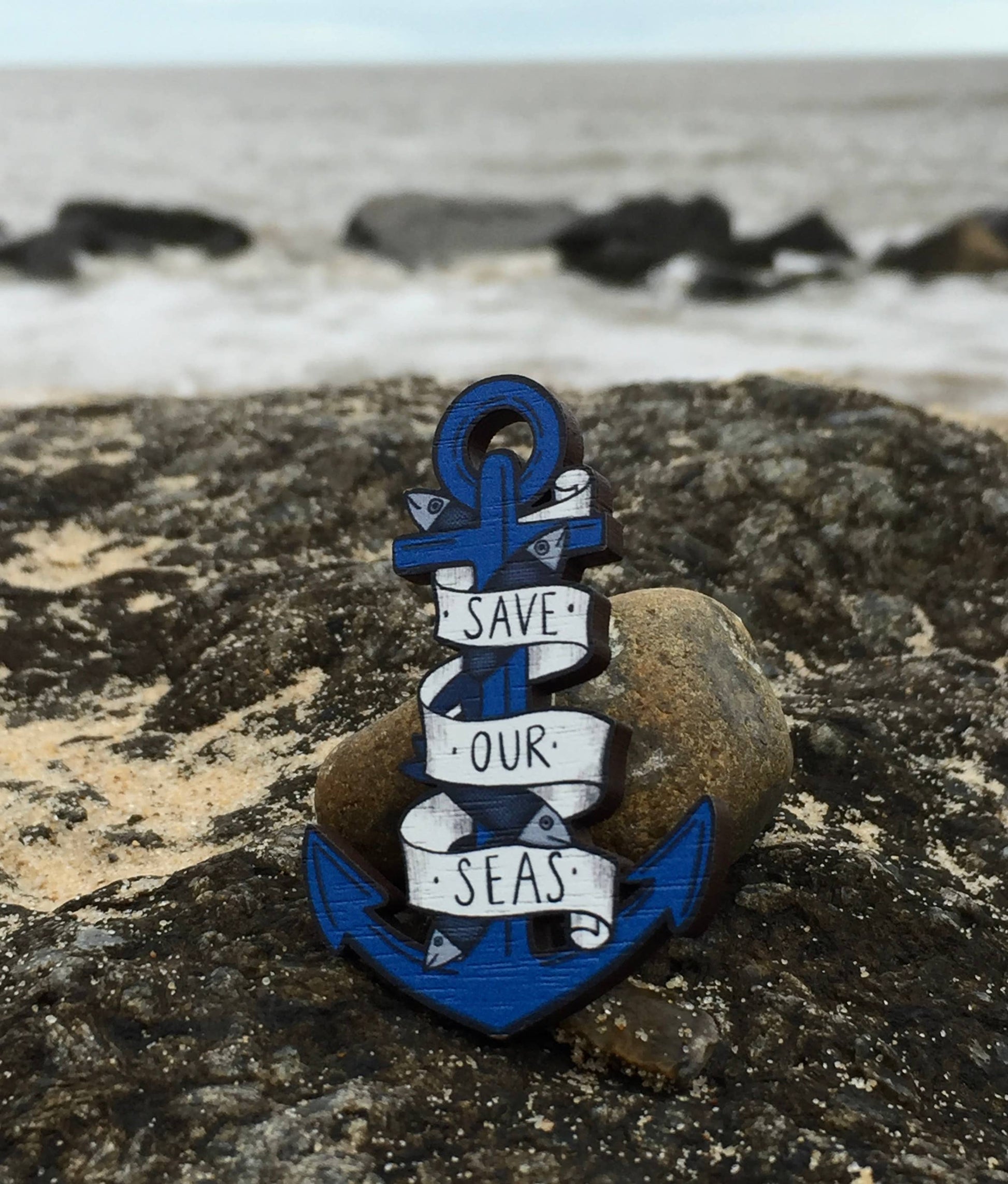 Wooden anchor pin badge showing metal bar back
