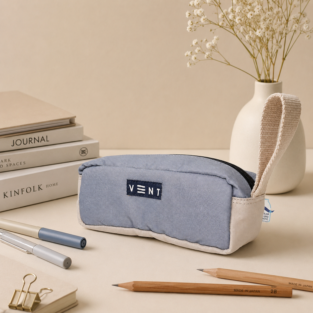 Side view of sustainable dusty blue pencil case showing webbing handle