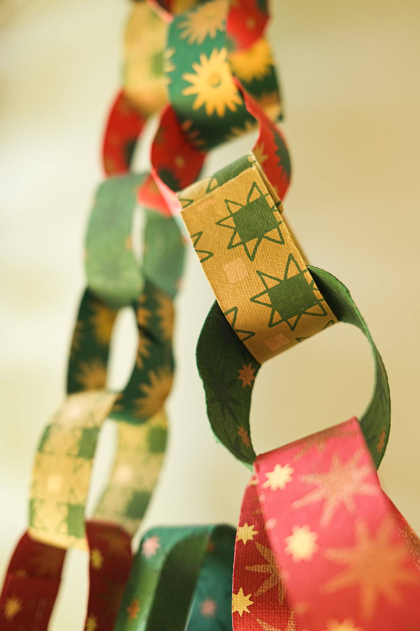 Recycled festive paper chain strips, hand-printed double-sided, eco-friendly decoration kit.