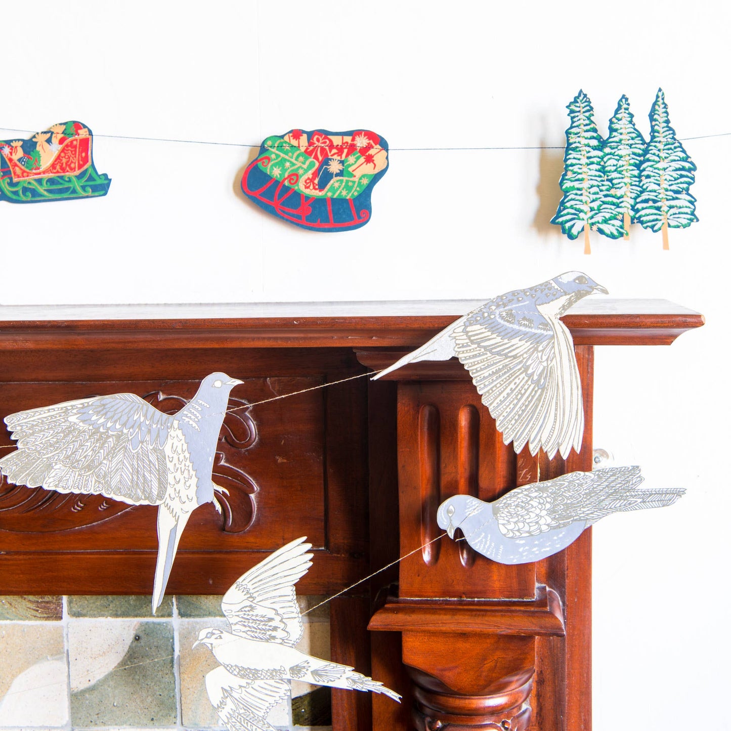 Screen printed Skyline Sewn Garland by East End Press with festive night time skyline images on recycled paper