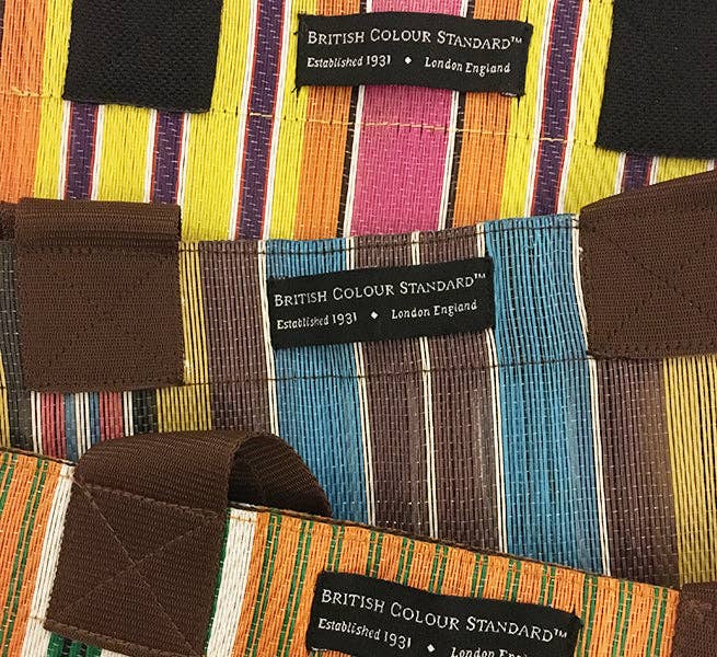 Eco Woven Market Shopper in Neyron, Guardsman and Pearl. A colourful, sustainable shopper with sturdy handles and a magnetic popper closure. This bag is made from threads spun from recycling old cement sacks!