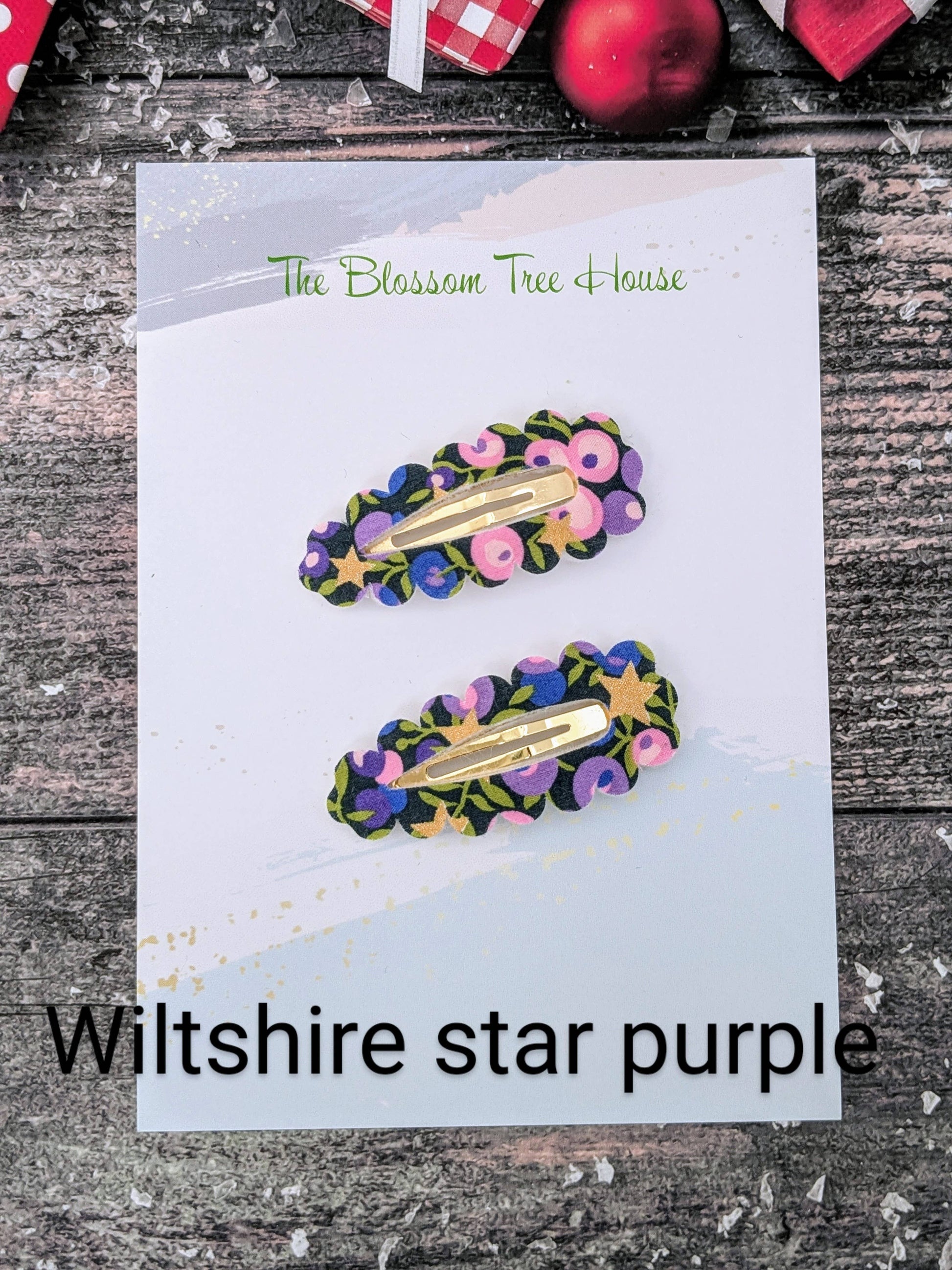 Two floral hair clips on a card labeled 'Wiltshire star purple' with 'The Blossom Tree House' branding.
