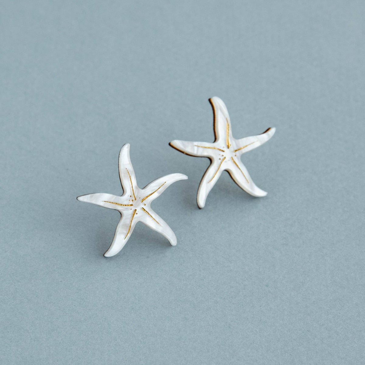 Pearly white starfish stud earrings with gold detailing