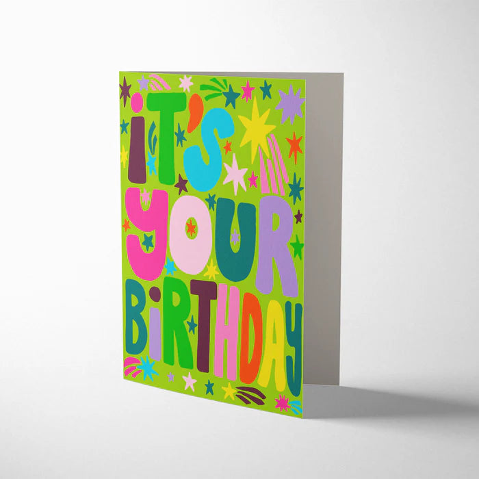 Close up of colourful birthday card by Jordan Sondler with cream envelope