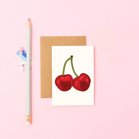 Mini Cherries Greeting Card displayed with a natural Kraft envelope, highlighting the sustainably sourced paper and blank interior, perfect for any occasion.