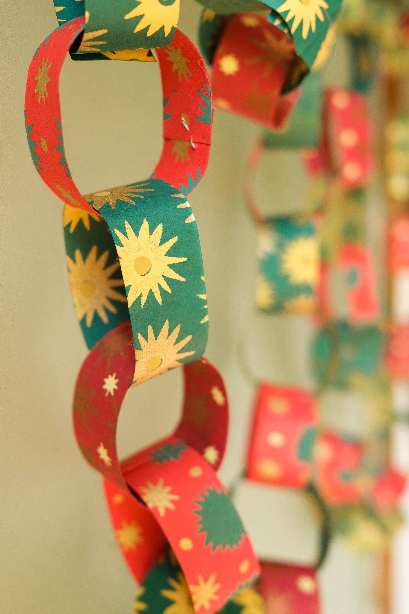Recycled festive paper chain strips, hand-printed double-sided, eco-friendly decoration kit.