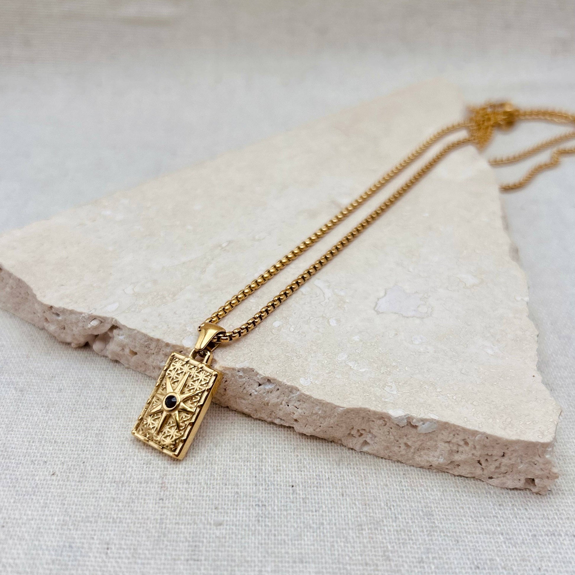 Little Nell Long Noir Rectangle Necklace with gold pendant and black star detail on adjustable 60cm chain.