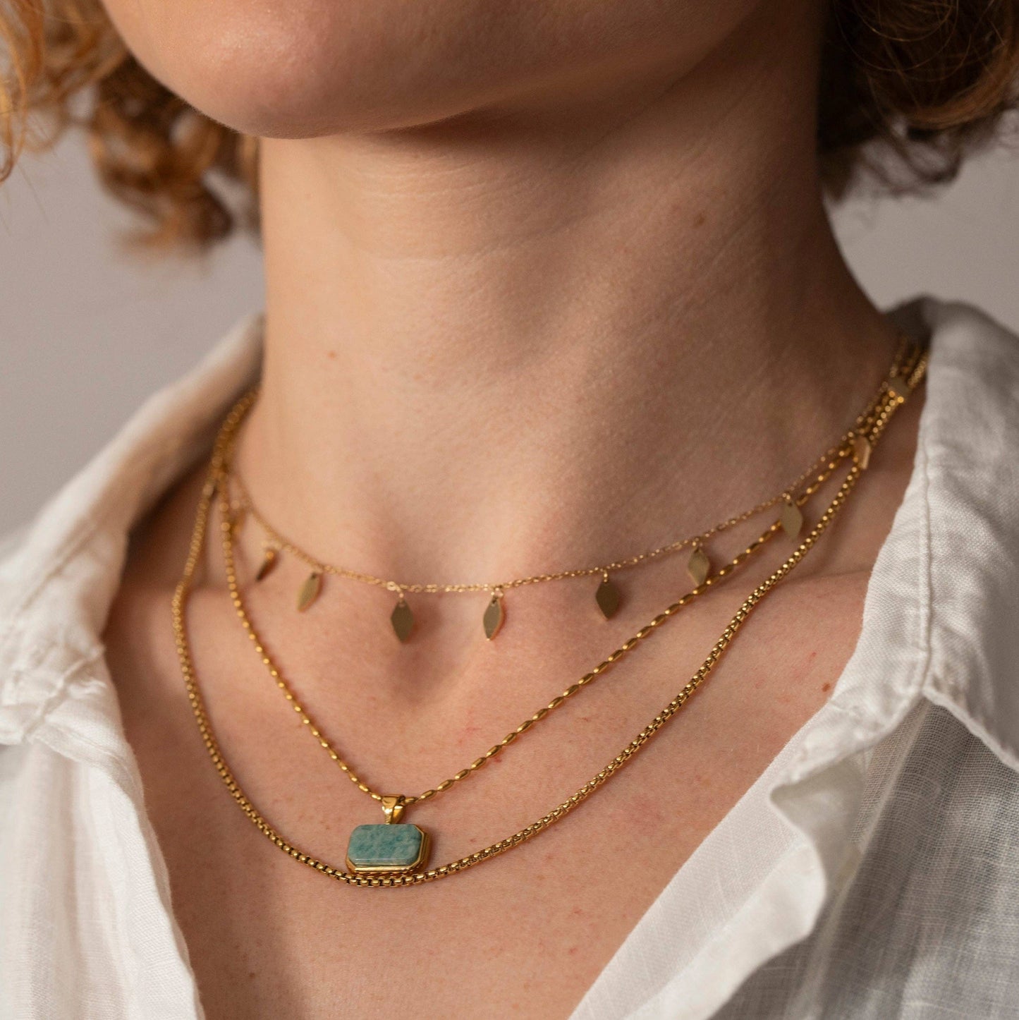 Close up of Turquoise Marble Pendant on Gold Dash Chain