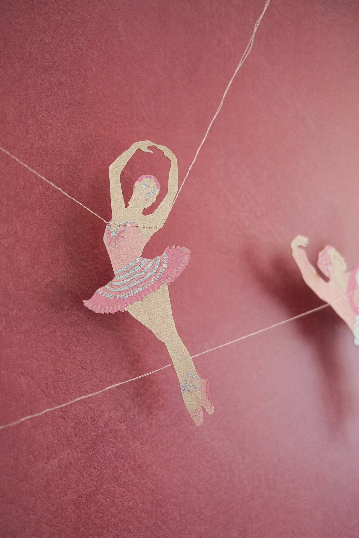 Ballerina dancer paper bunting draped across a room