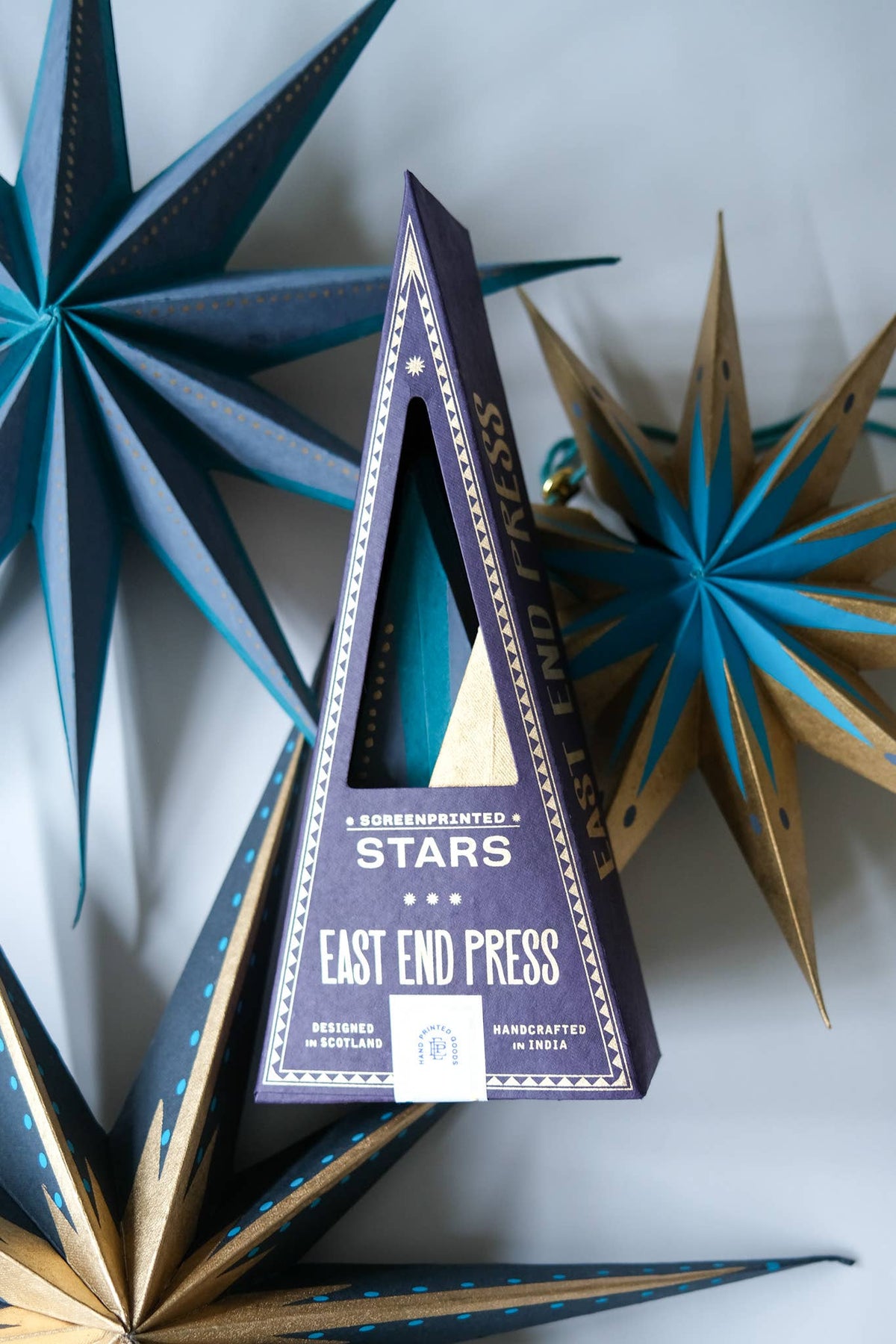 Set of three hand-printed recycled paper shining star hanging decorations