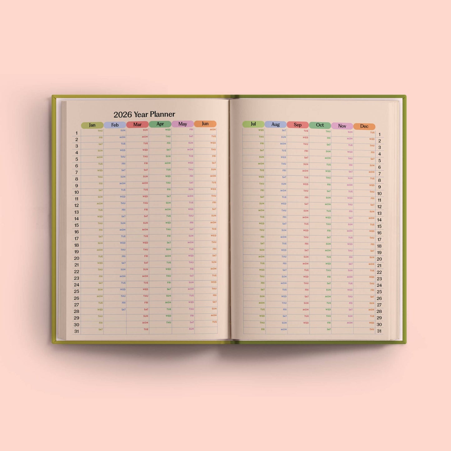 2026 year planner open to a pink background. 2026 Weekly Planner by Good Tuesday—cobalt blue hardback, starburst pattern, A5, recycled, UK made.