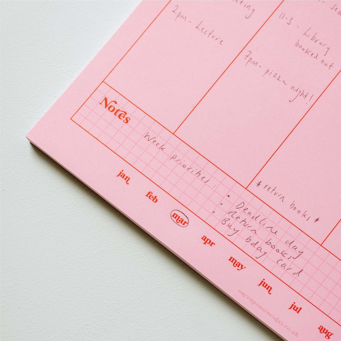 Close-up of the A4 Pink & Red Weekly Planner Pad showing the recycled paper texture and 'Notes' section.