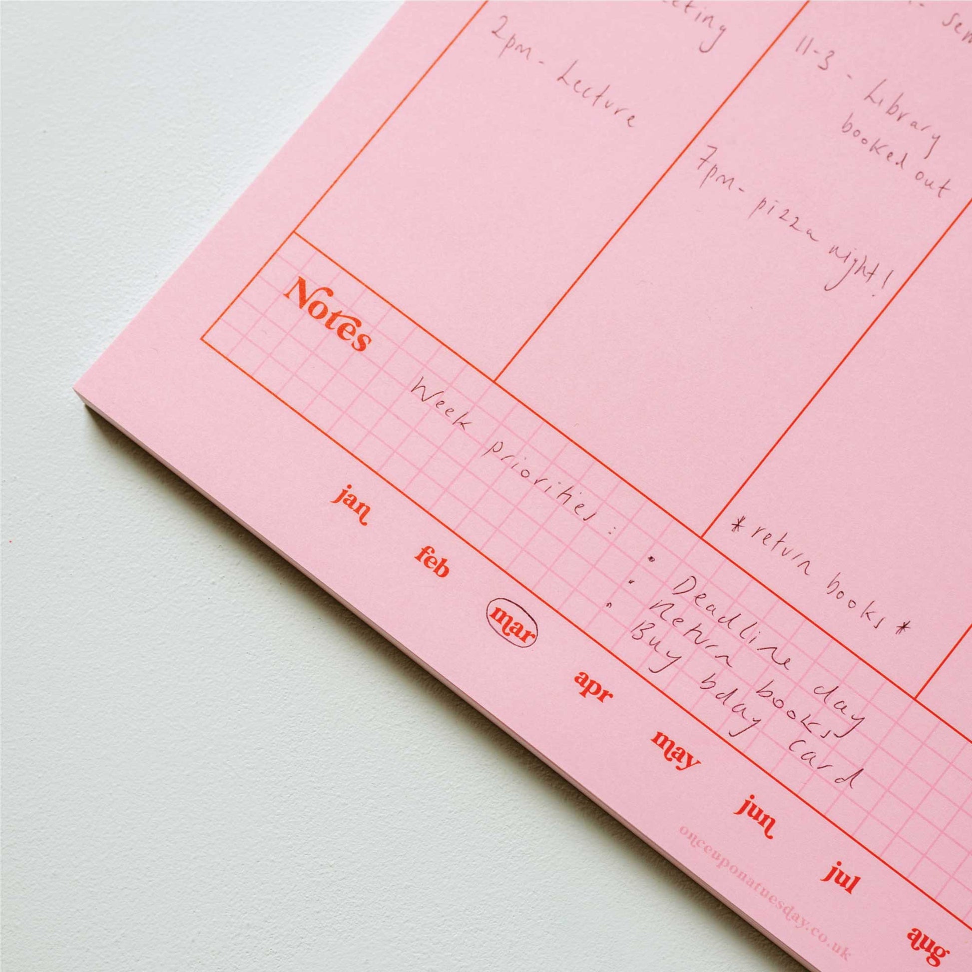 Close-up of the A4 Pink & Red Weekly Planner Pad showing the recycled paper texture and 'Notes' section.