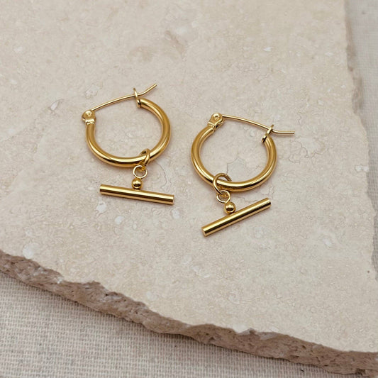 Pair of Little Nell lightweight gold bar hoops with removable charm, waterproof and hypoallergenic