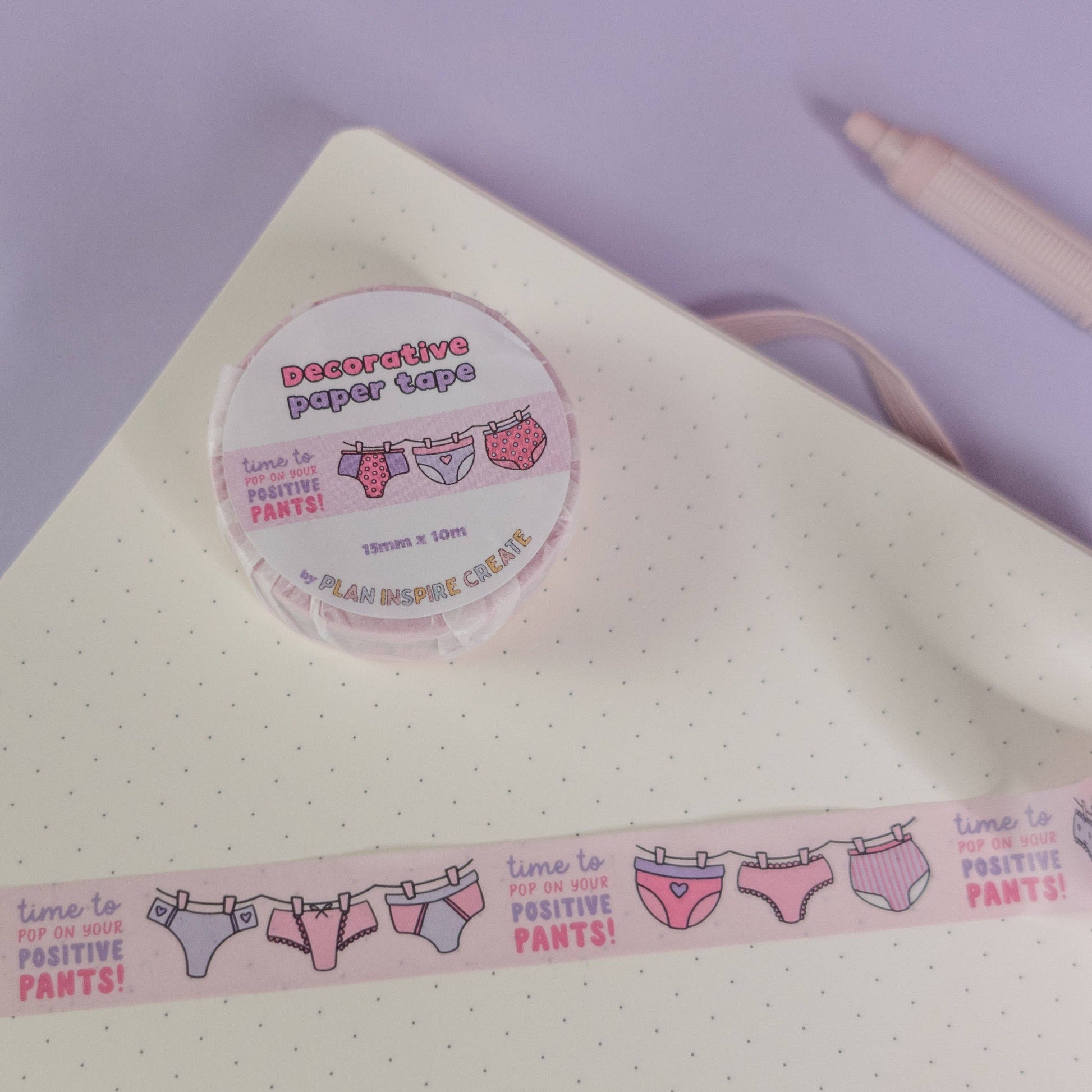Pink and purple patterned pants washi tape with “pop on your positive pants” message and eco-friendly paper packaging—perfect for uplifting journaling and craft projects.